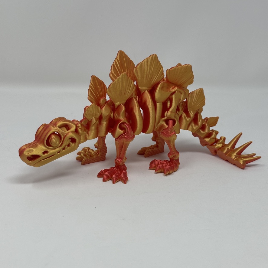 Gold and red articulated stegosaurus 3D print